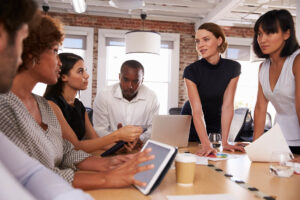 businesspeople meeting around table in modern offi PYML4WH 1